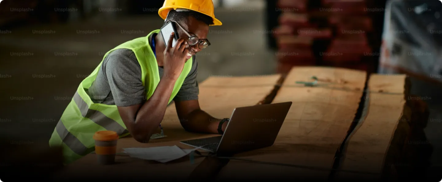 Man on phone using laptop