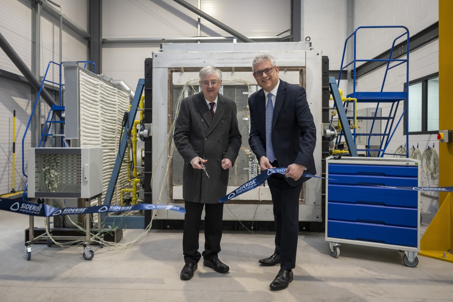Mark Drakeford and Adam Turk Cutting a Ribbon